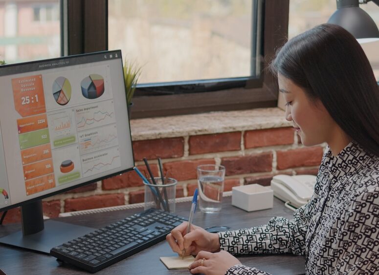 Analytics dashboard, market research charts, data analysis on screens.